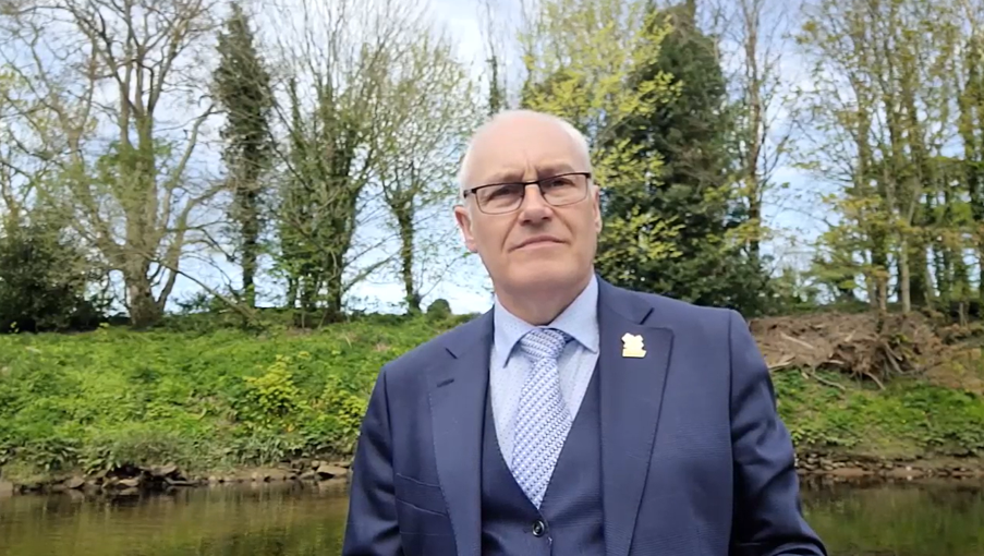 Brian Porter delivering a personal eulogy beside a river