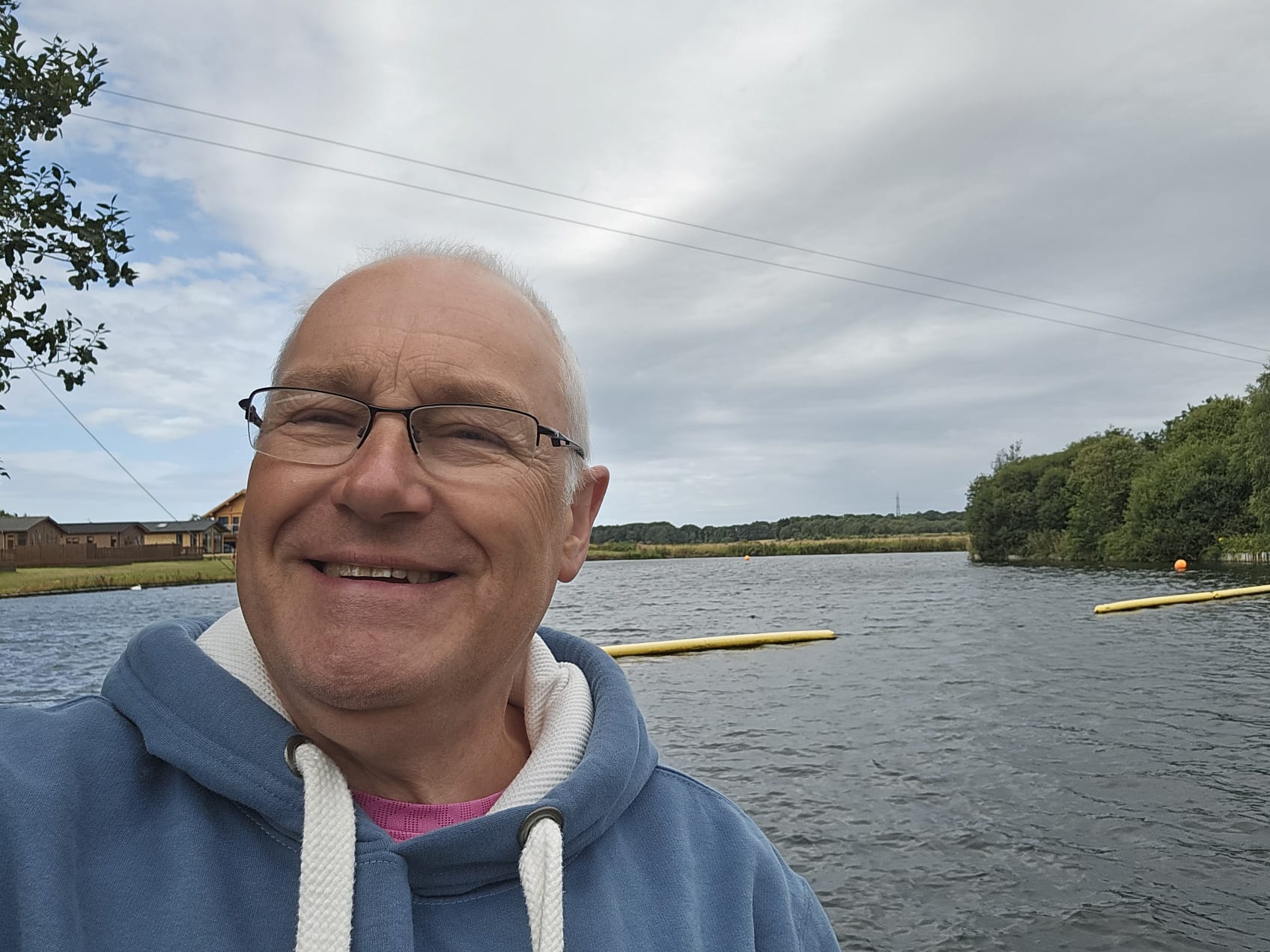 Brian Porter smiling beside an open-water swimming lake